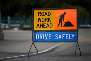 RoadsignthatsaysRoadWorkAhead-DriveSafely
