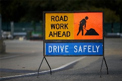 RoadsignthatsaysRoadWorkAhead-DriveSafely