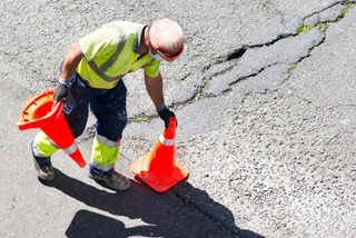 Roadworkerplacingtrafficconesonaroad