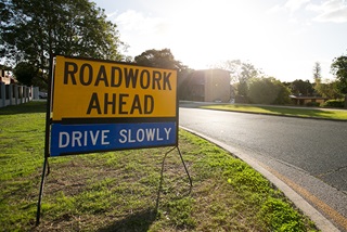RoadworkAhead-DriveSlowlysignonasuburbanstreet