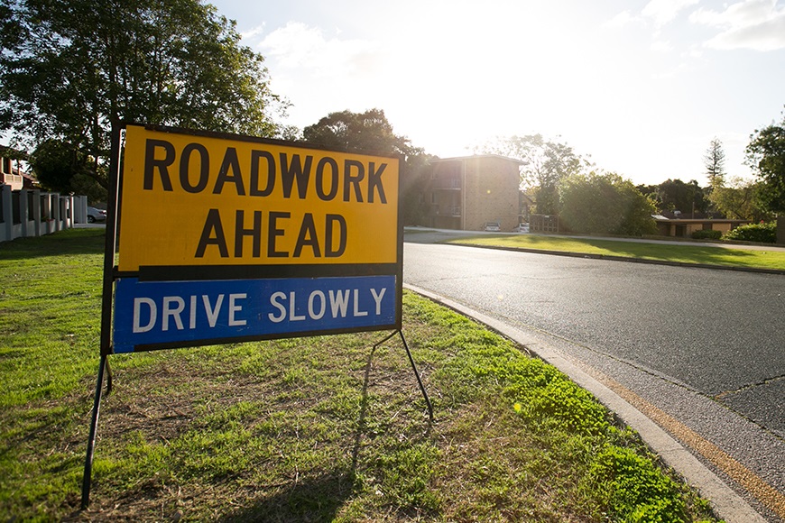 RoadworkAhead-DriveSlowlysignonasuburbanstreet