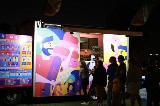 Peopleliningupatacolourfulfoodtruck
