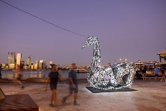 Alargeilluminatedswaninstallationnexttoariver