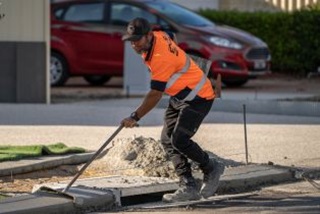 Aroadworkerworkingonadrain
