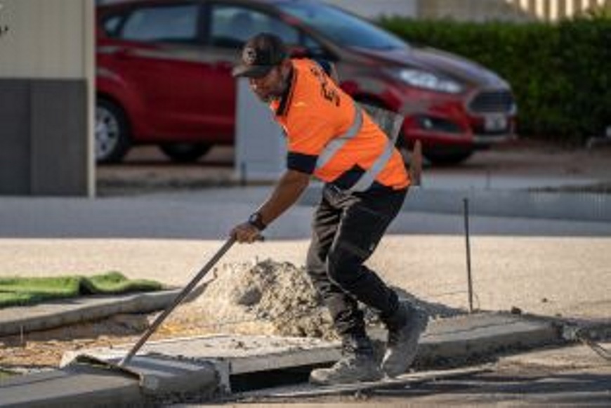 Aroadworkerworkingonadrain