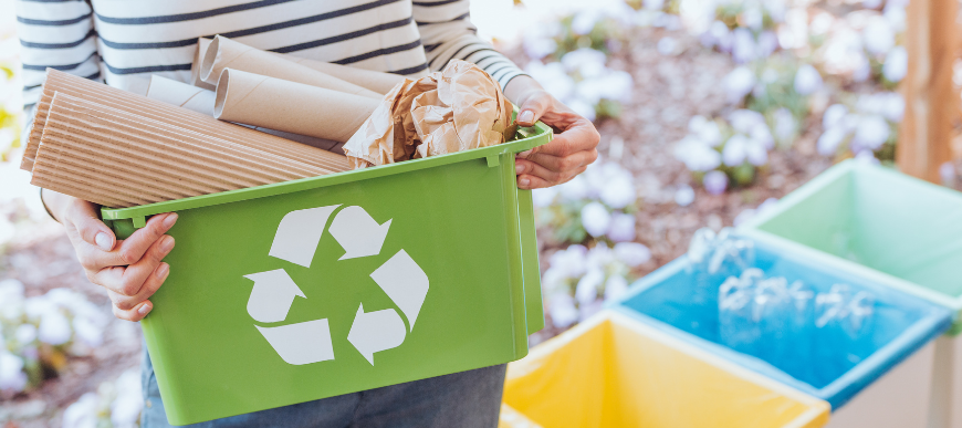 Someoneholdingarecyclingtubfilledwithpaperandcardboard