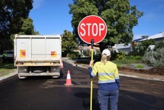 AroadworkerholdingaStopsign