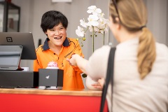 A Workpower worker serving a customer at the Reuse Shop