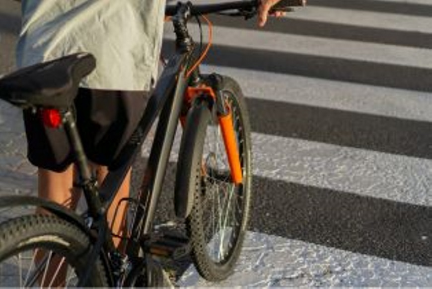 Apersonpushingabikeacrossazebracrossing