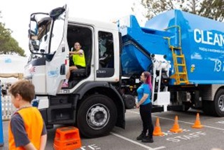 AchildsittinginaCleanawayrecyclingtruck