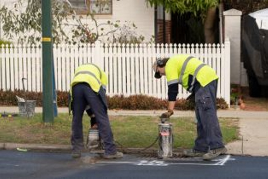 Roadworkersworkingonadrain