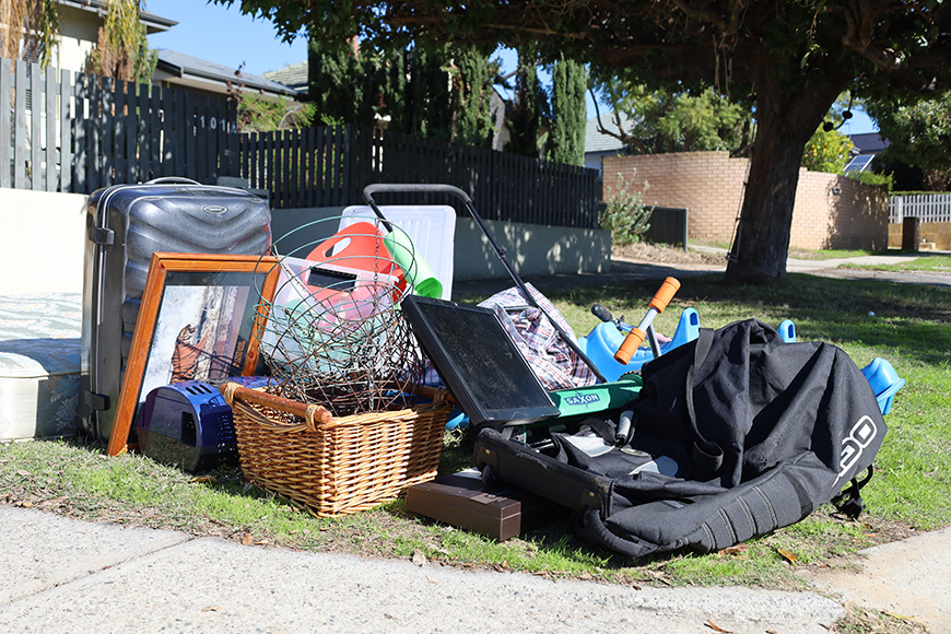 A pile of various household items on someone's verge