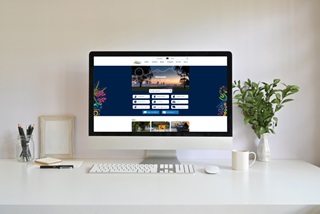 AcomputermonitoronadeskwiththeCityswebsiteonscreen