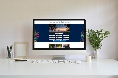AcomputermonitoronadeskwiththeCityswebsiteonscreen
