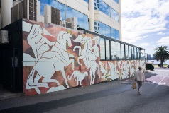 A wall mural with white horses and people mounted on them.