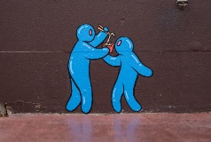 A wall mural with two blue characters sharing noodles from a single bowl.